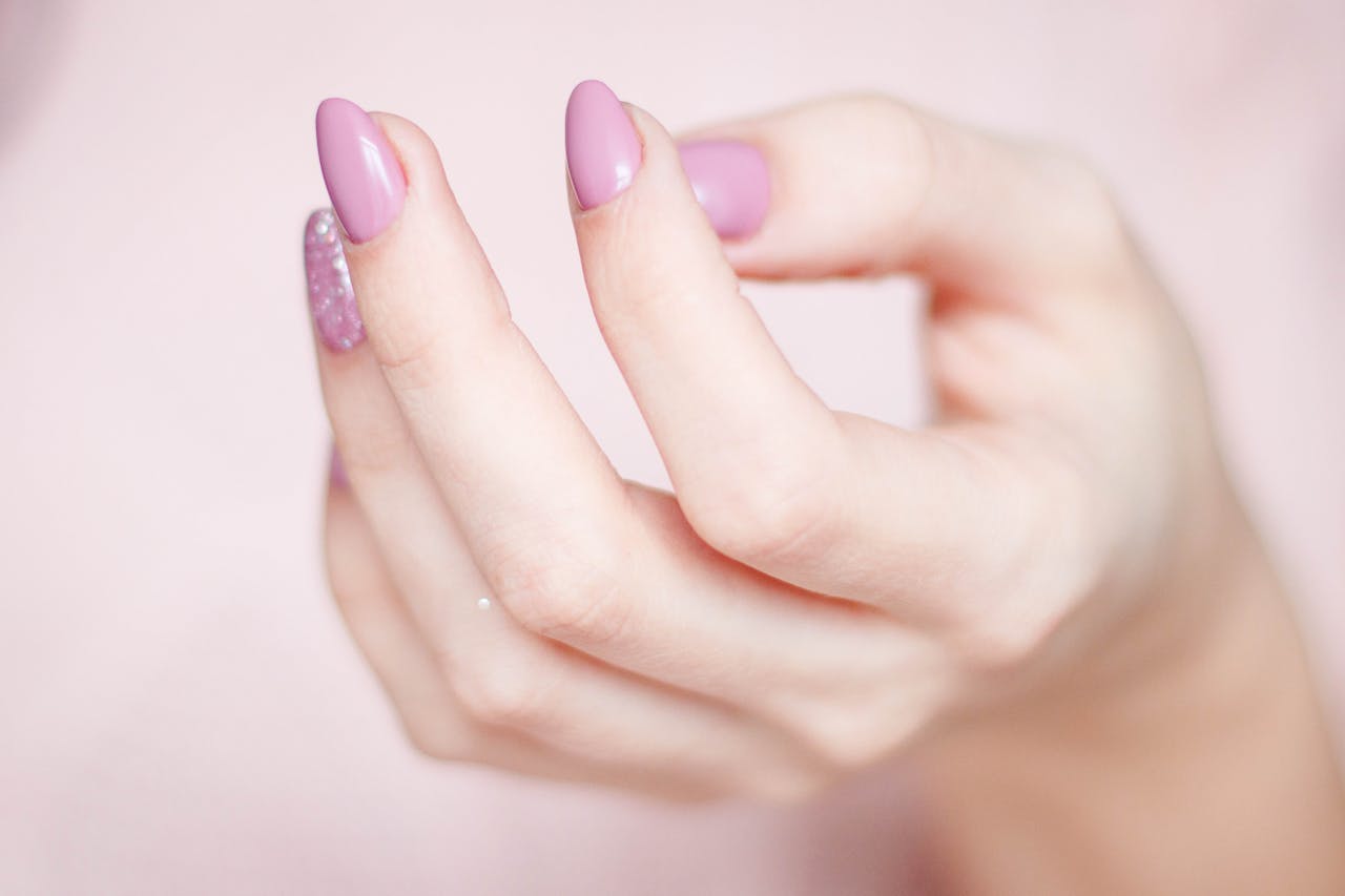 Persons Hand With Pink Manicure